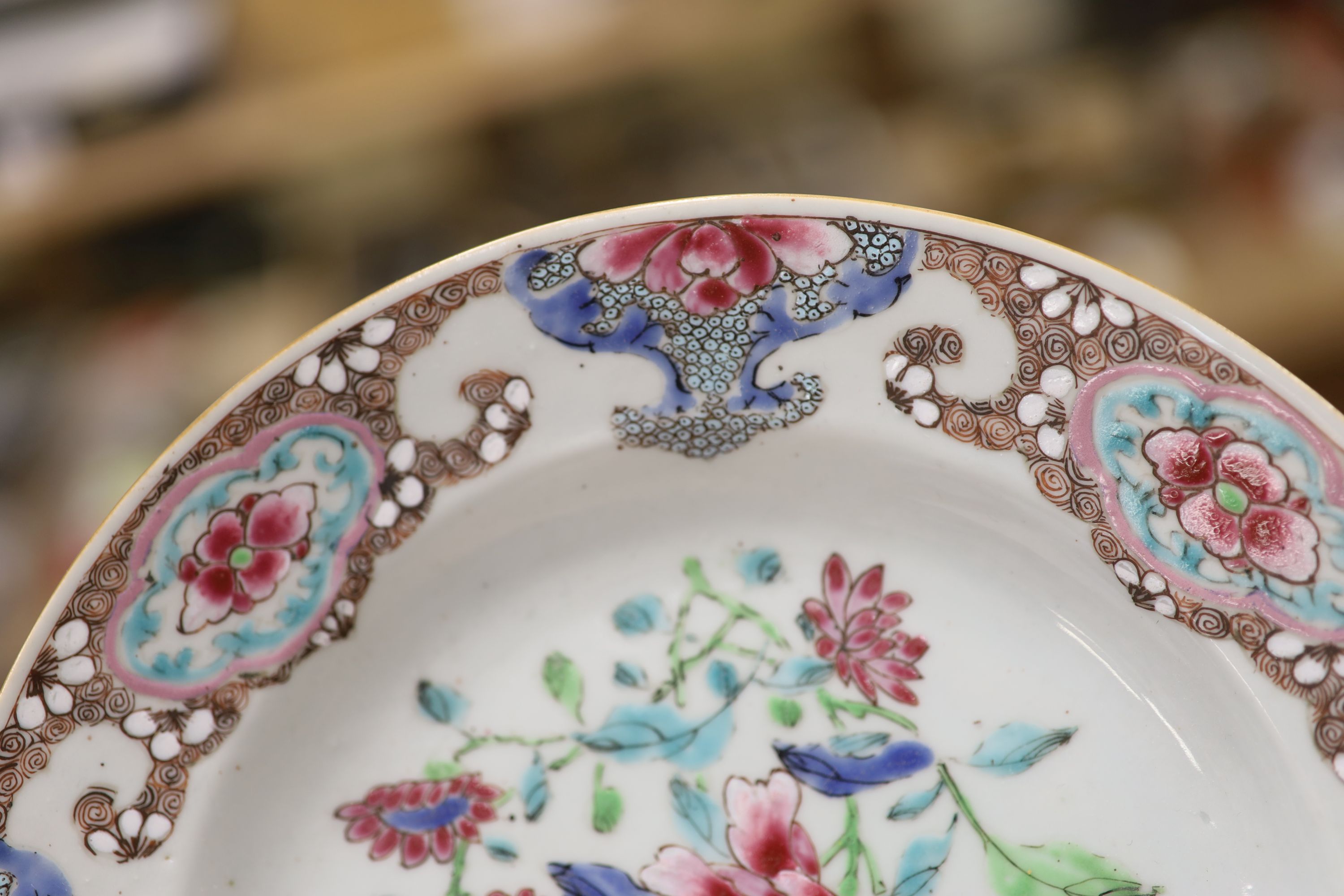 A pair of 18th century Chinese famille rose plates and another similar, largest diameter 22.5cm (damage)